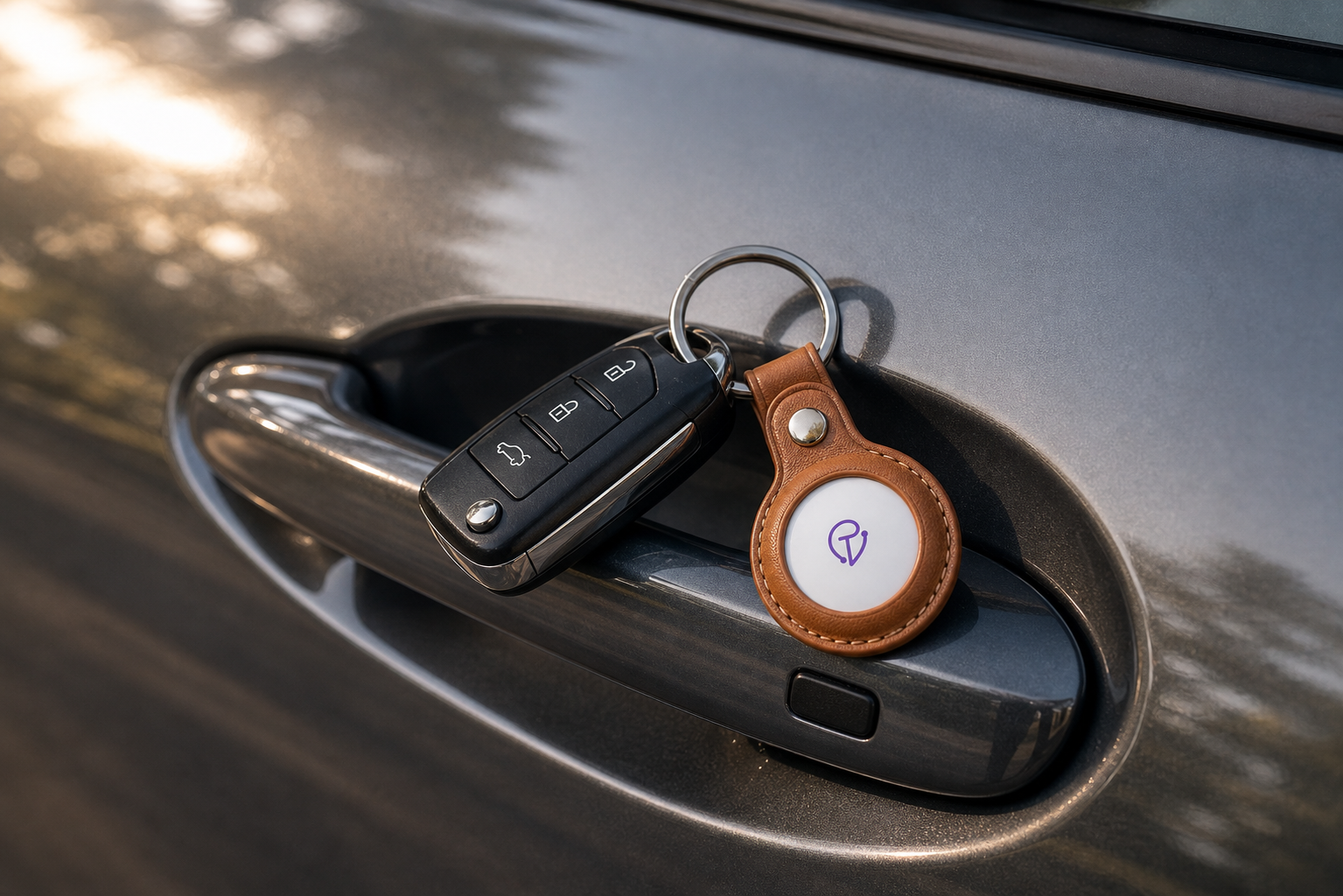 Tracker Mist coin fob on a car console beside a key fob